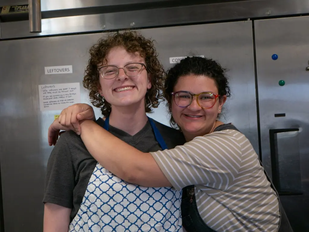 Madison (right) and another Resident, Amanda working in the kitchen