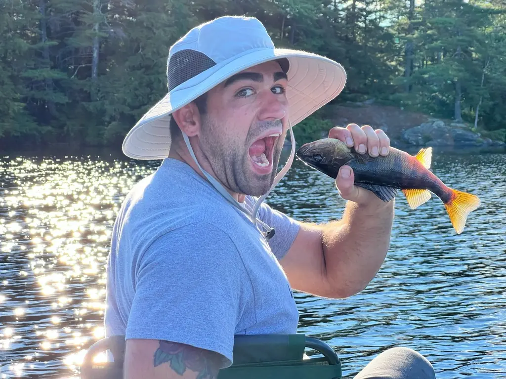 Joshua fishing with staff and friends