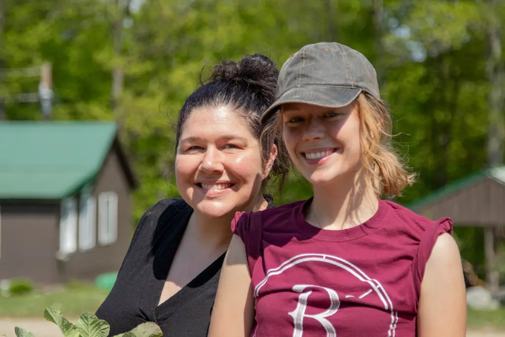 Ashley (left) our most recent graduate, and Erin a Servant Leader, planting crops in the garden