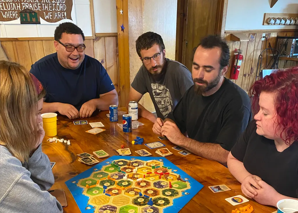 Pictured left: Servant Leaders, Residents, and staff enjoying a game of Settlers of Catan at our Memorial Day celebration.